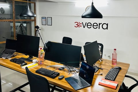 Inside the Aveera Design Solutions studio in Pune, with the अ:veera wordmark on the wall