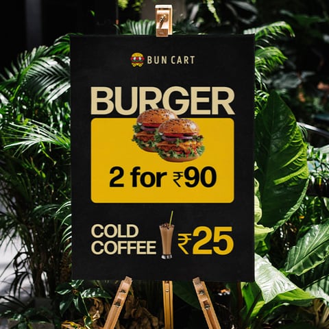 Bun Cart A-frame standee showing a two-for-ninety burger offer and cold coffee price