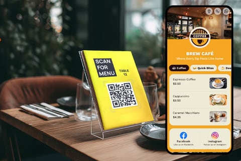 Acrylic QR table tent beside a phone displaying a digital café menu, designed by Aveera Design Solutions